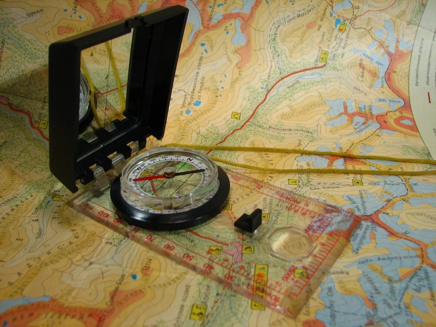 A compass and map on the floor of an area.